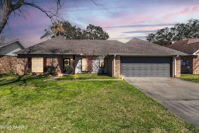 single story home featuring a yard and a garage