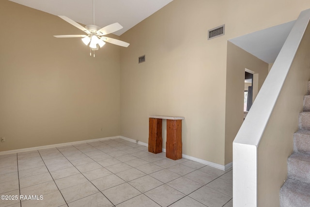 empty room with stairway, ceiling fan, visible vents, and baseboards