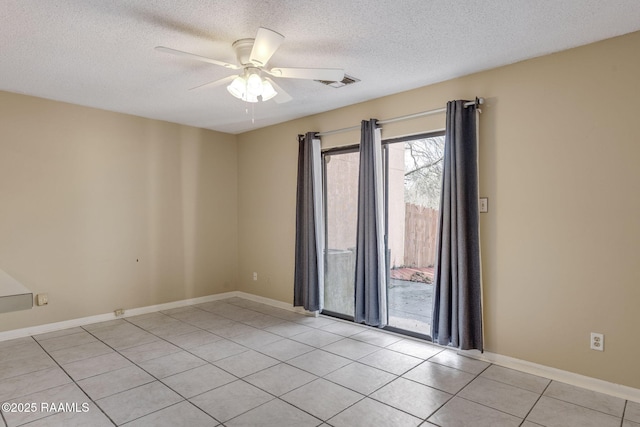 unfurnished room featuring light tile patterned floors, baseboards, visible vents, a ceiling fan, and a textured ceiling