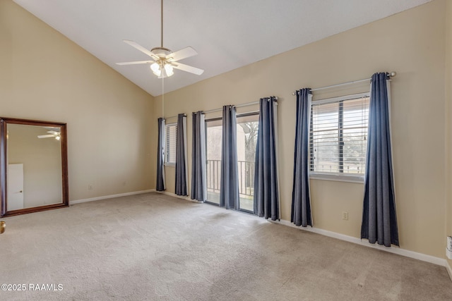 spare room with high vaulted ceiling, carpet flooring, a ceiling fan, and baseboards