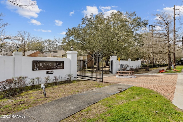 community sign with fence and a gate