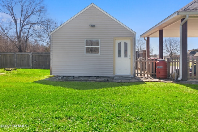 view of outbuilding featuring a gate, fence, and an outdoor structure