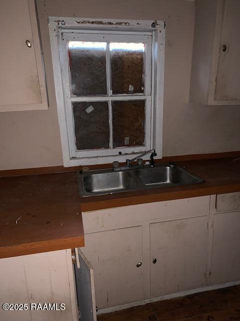 kitchen with white cabinetry and sink