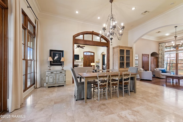 dining area featuring arched walkways, recessed lighting, visible vents, and crown molding