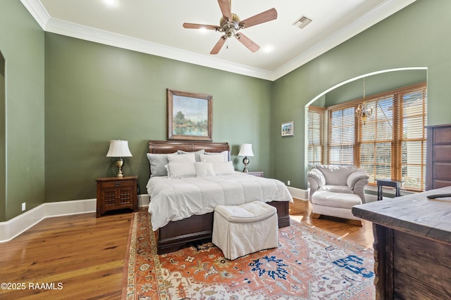 bedroom featuring ornamental molding, visible vents, and baseboards