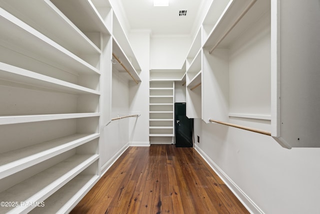 spacious closet with visible vents and hardwood / wood-style flooring