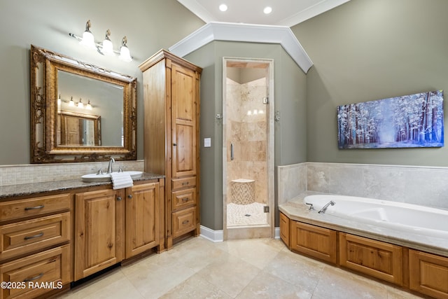 bathroom with a bath, vaulted ceiling, vanity, a shower stall, and backsplash