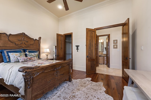 bedroom featuring ornamental molding, a ceiling fan, baseboards, and wood finished floors