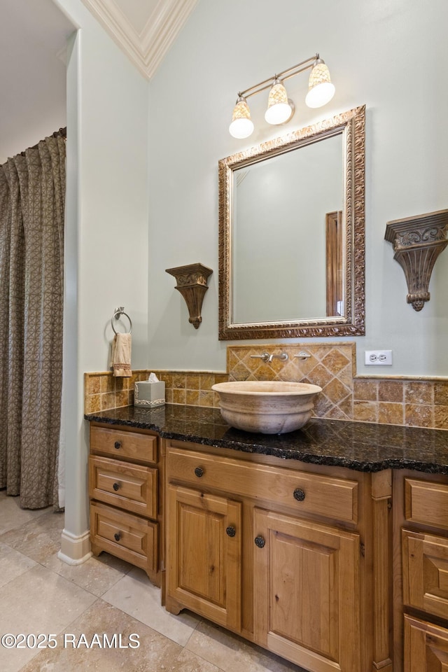 bathroom with ornamental molding, tile patterned flooring, vanity, and decorative backsplash