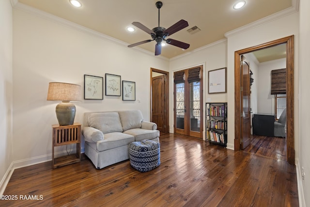 living area featuring french doors, visible vents, hardwood / wood-style floors, ornamental molding, and baseboards