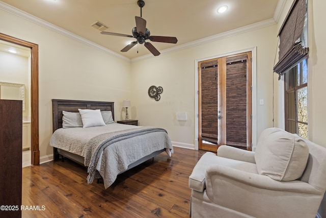 bedroom with dark wood finished floors, visible vents, and crown molding