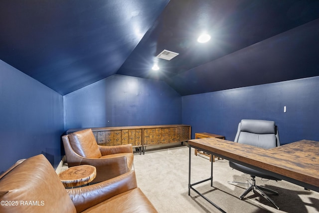 carpeted office with visible vents and vaulted ceiling