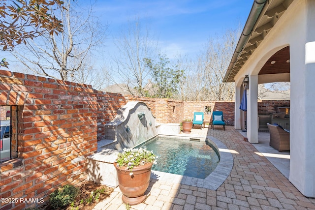 view of pool with a patio area and fence