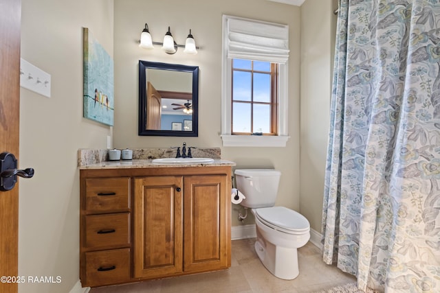 full bathroom with toilet, a shower with curtain, baseboards, and vanity