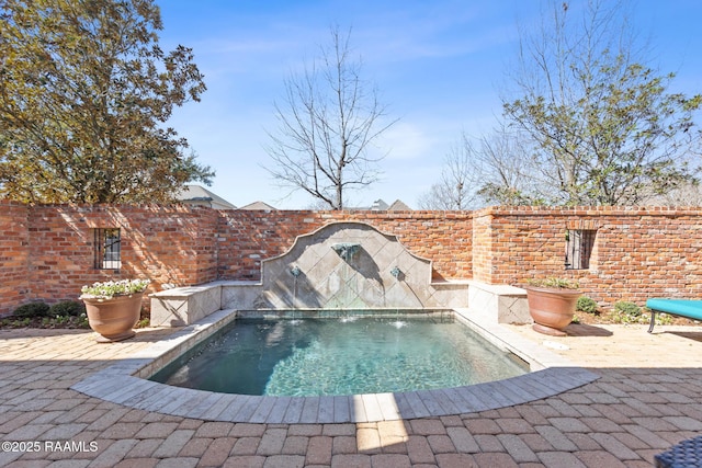 view of pool with a patio area and a fenced backyard