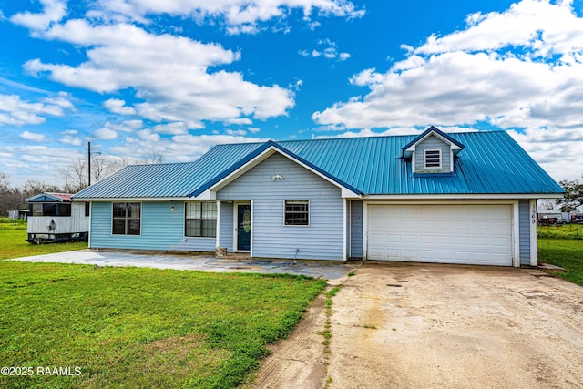 view of front of home with a front lawn, a garage, metal roof, and driveway