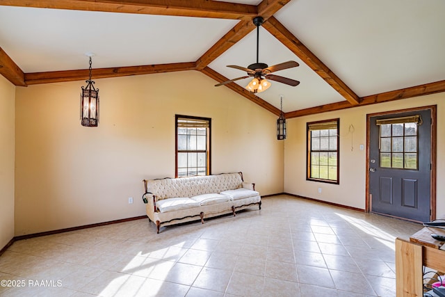 interior space featuring baseboards, a healthy amount of sunlight, and lofted ceiling with beams