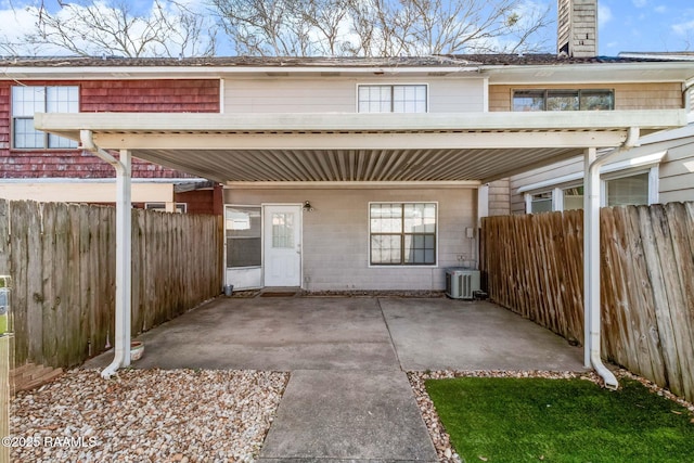 exterior space with a chimney, fence, a patio, and central AC unit