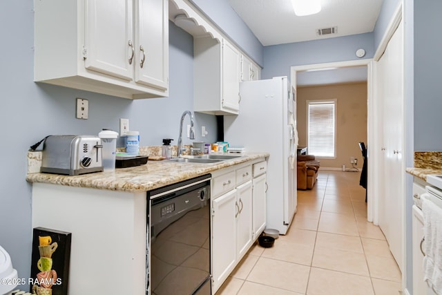 kitchen with light tile patterned flooring, a sink, visible vents, white cabinetry, and dishwasher