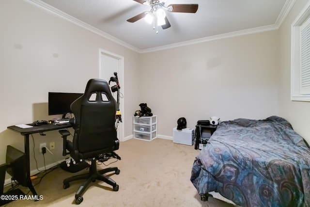 carpeted bedroom featuring crown molding, baseboards, and ceiling fan