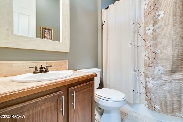 bathroom featuring tile patterned flooring, vanity, and toilet