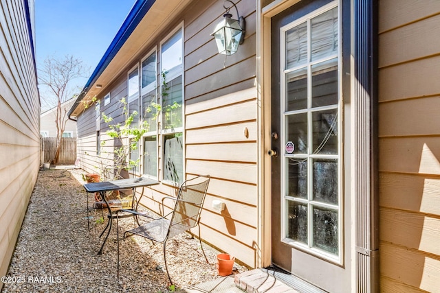 view of side of home featuring fence