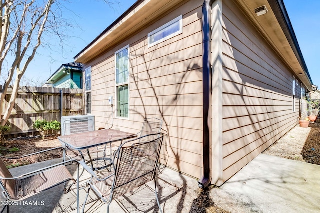 exterior space featuring a patio area, fence, and outdoor dining area