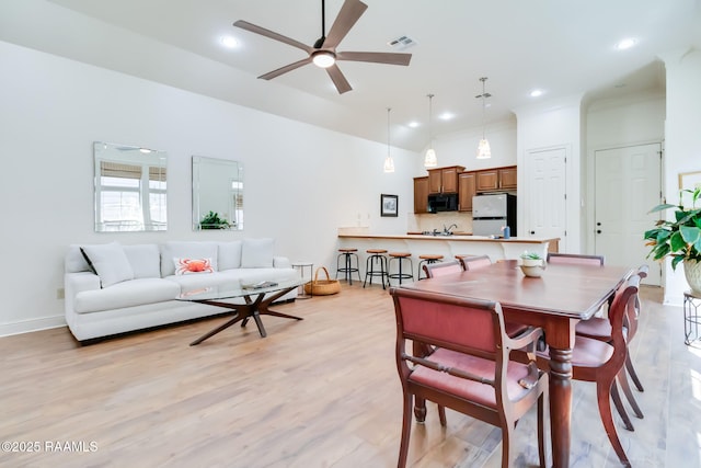 dining space with ceiling fan, recessed lighting, a towering ceiling, visible vents, and light wood-type flooring