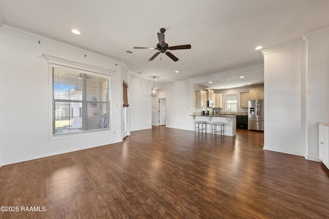 unfurnished living room featuring ceiling fan, ornamental molding, dark wood-type flooring, a sink, and recessed lighting