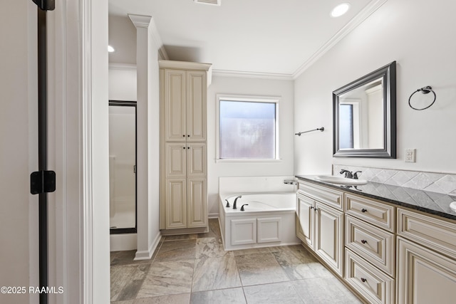 bathroom featuring a garden tub, visible vents, vanity, a stall shower, and crown molding