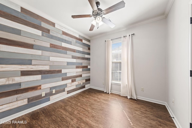 unfurnished room featuring crown molding, a ceiling fan, wood walls, and wood finished floors