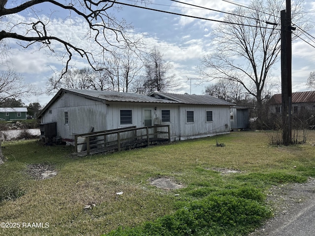 view of front facade with a front yard and metal roof