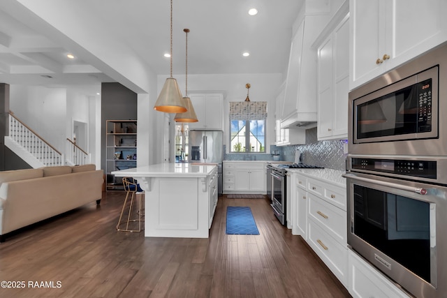 kitchen with dark wood-style floors, open floor plan, recessed lighting, decorative backsplash, and high quality appliances
