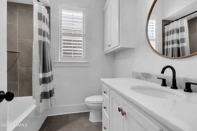 bathroom featuring a wealth of natural light, toilet, vanity, and tile patterned floors