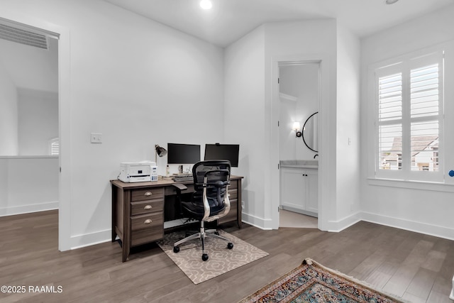 office featuring baseboards, wood finished floors, and recessed lighting