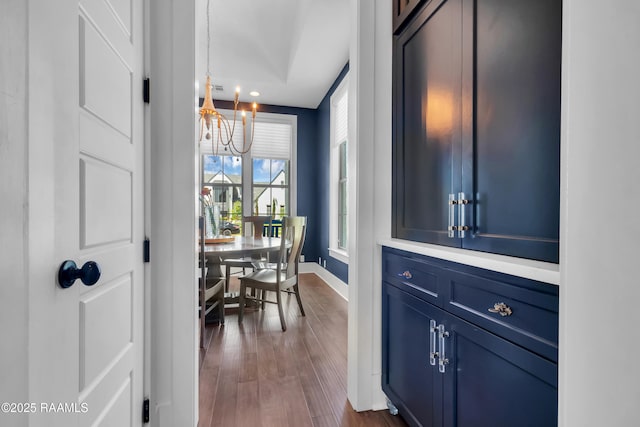 interior space with recessed lighting, dark wood-style flooring, a notable chandelier, and baseboards