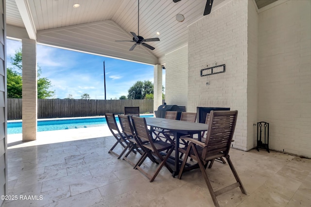 view of patio with a fenced backyard, outdoor dining space, a fenced in pool, and ceiling fan