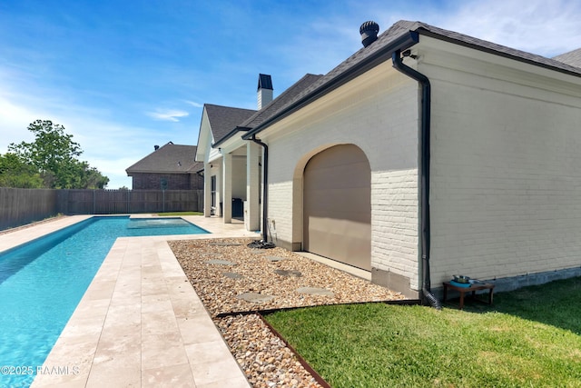 view of swimming pool with a fenced backyard, a patio area, and a fenced in pool