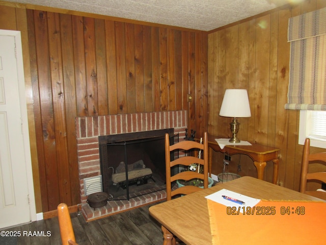 interior space with a fireplace, hardwood / wood-style flooring, and wooden walls