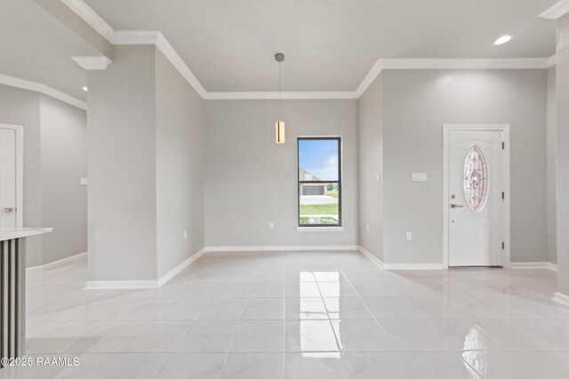 entrance foyer with baseboards, ornamental molding, and light tile patterned floors