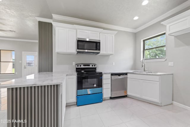 kitchen with white cabinets, a peninsula, a sink, recessed lighting, and appliances with stainless steel finishes