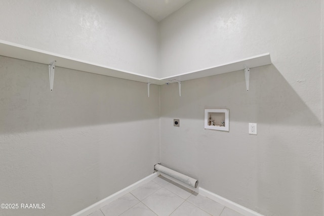 laundry area featuring laundry area, light tile patterned flooring, hookup for a washing machine, baseboards, and electric dryer hookup