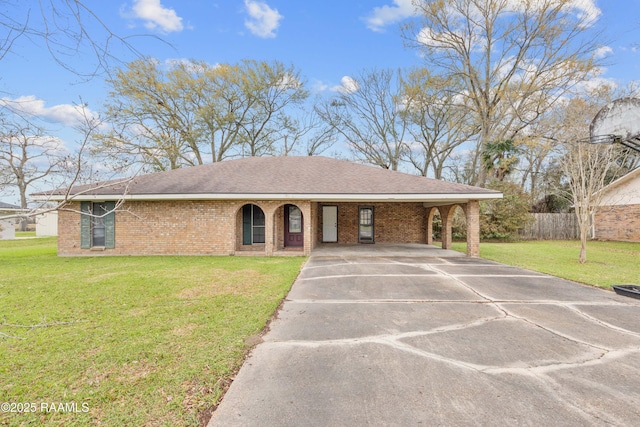 ranch-style house featuring a front yard and a carport