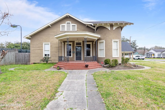 bungalow featuring fence, a porch, and a front lawn