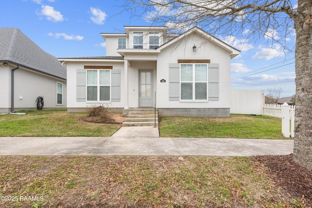 bungalow-style house with a balcony, fence, a front lawn, and stucco siding