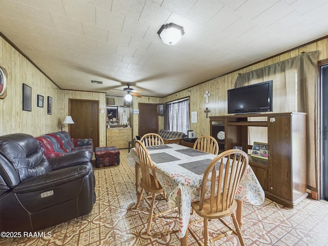 dining room with ornamental molding, visible vents, and a ceiling fan