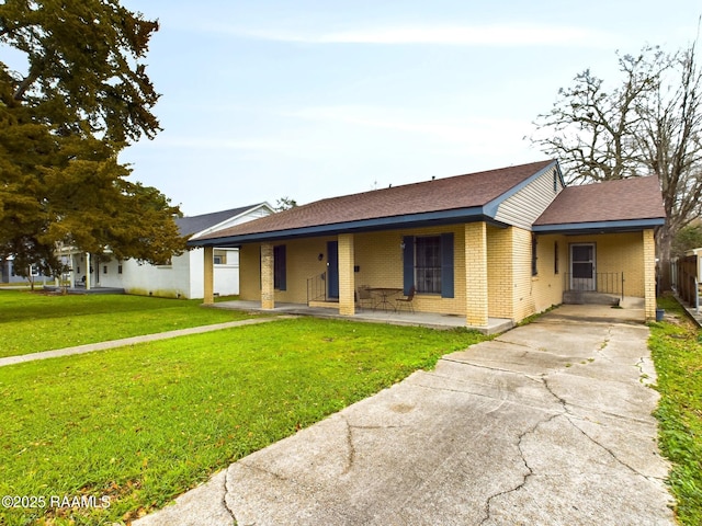 ranch-style house with brick siding and a front lawn