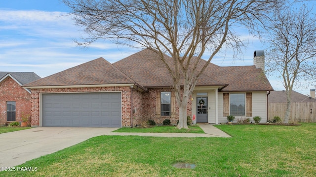 view of front of home featuring an attached garage, brick siding, fence, a front lawn, and a chimney