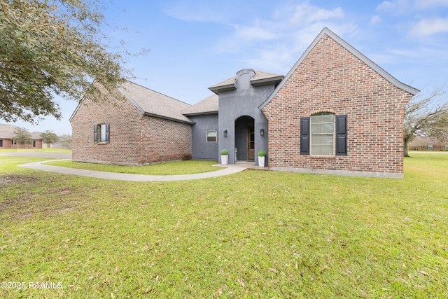 view of front of house with a front lawn and brick siding