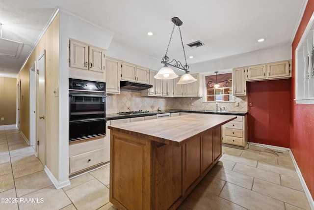 kitchen with a warming drawer, stainless steel gas cooktop, under cabinet range hood, wood counters, and black oven